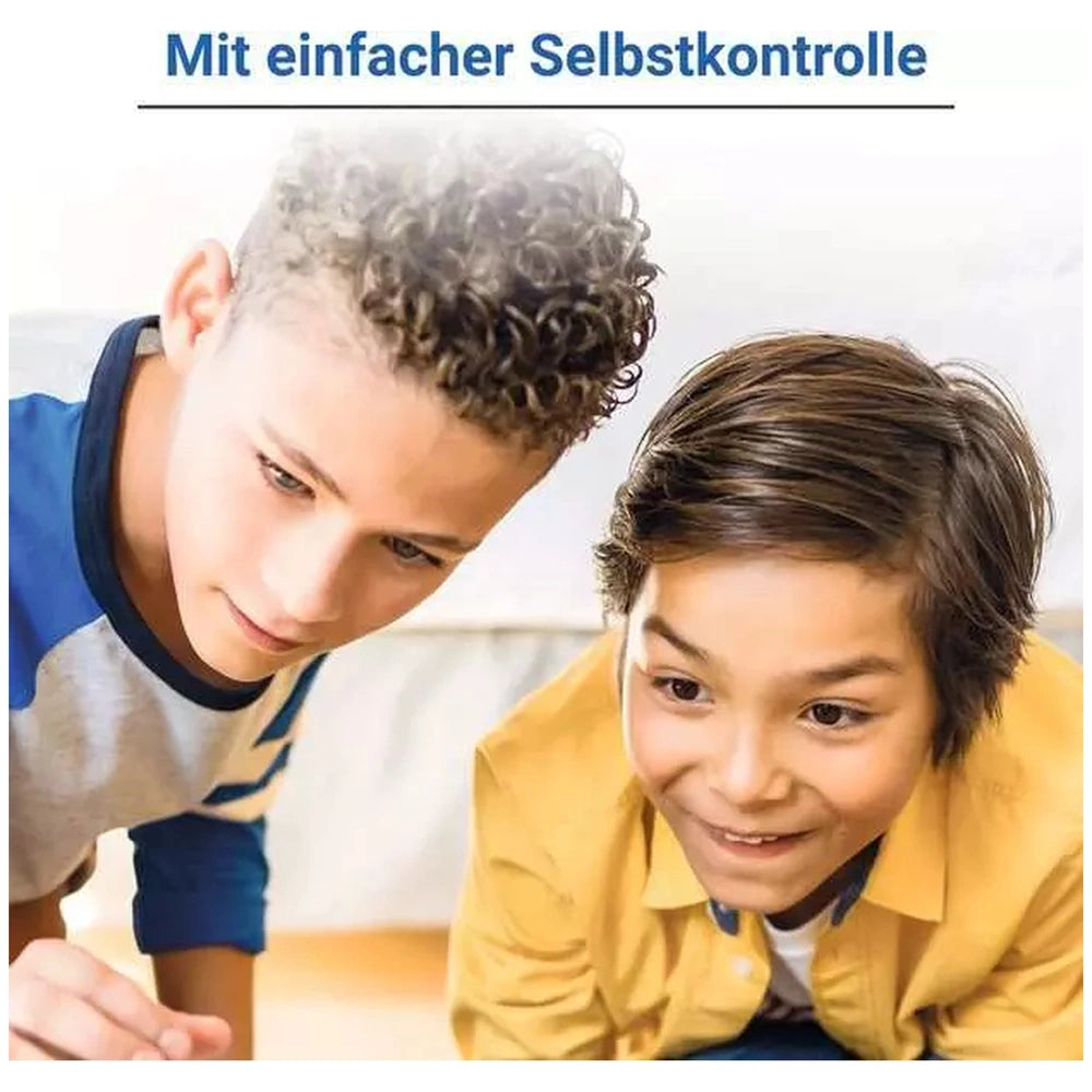 Ravensburger - 1X1 Drachen board game is showcased with two boys engaged in a digital activity on a carpeted floor.