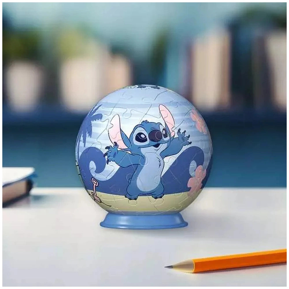 3D puzzle ball featuring a playful blue creature with pink and yellow accents, placed on a white surface with a pencil nearby