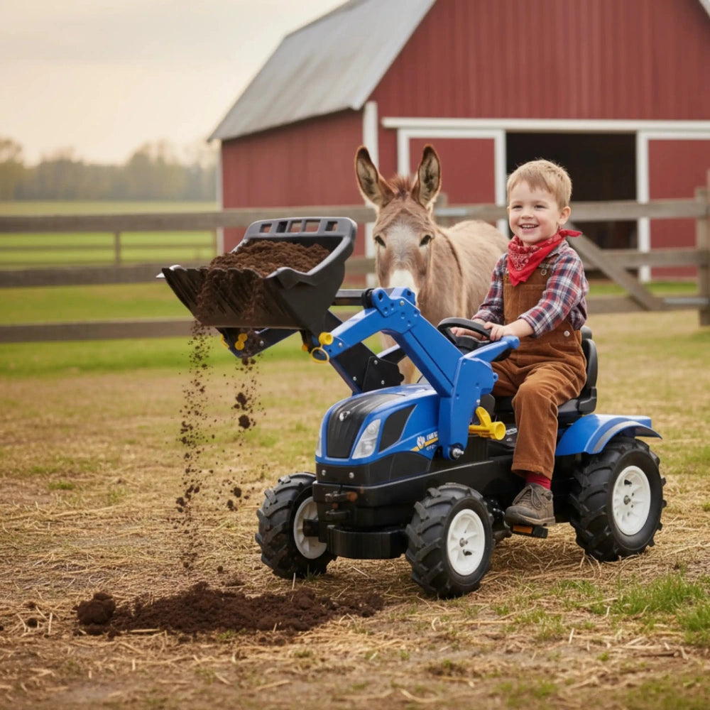 Child riding Rollyfarmtrac New Holland four-wheeler with inflatable wheels near a red barn and piles of hay and dirt.