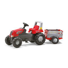 Red toy tractor with a black seat and large wheels, attached to a gray and red trailer, set against a plain white background.