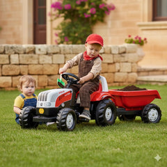 Rolly Toys Rollykid Steyr 6165 CVT tractor in red and black, with children in gray overalls playing on green grass.