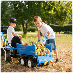 Rollymega Trailer filled with green and red apples, as two boys in white shirts and blue caps collect them in a grassy area.