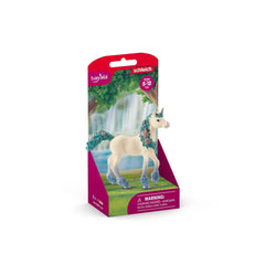 Schleich Blossom Unicorn Foal toy figure in red packaging with a printed image of a white unicorn and warning label.