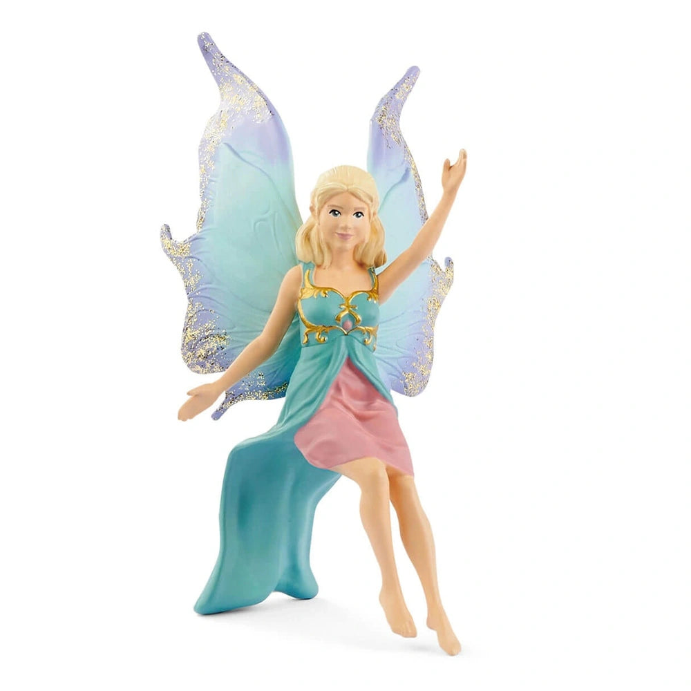 Schleich Bayala fairy doll with blonde hair, blue and pink dress, and glittery blue and gold wings on a winged lion.