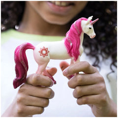 Schleich Bayala Mandala Unicorn figurine with a white body and glossy pink mane, tail, and hoof, made of smooth plastic.