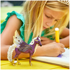Schleich Star Pegasus Mare figurine in purple with white mane, alongside a girl in a green top holding a yellow pencil.