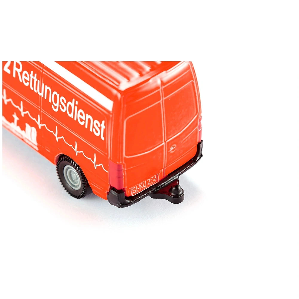 Red toy ambulance with glossy finish, white accents, and "2 Rettungsdienst" text on the side, featuring wheels and windows.