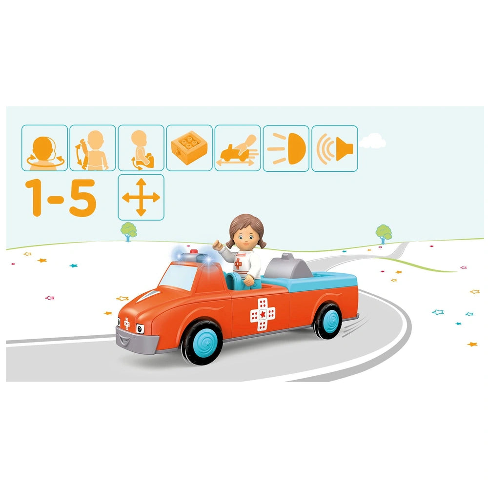 A young girl in a white shirt with a red cross drives an orange toy car on a bright, animated landscape.