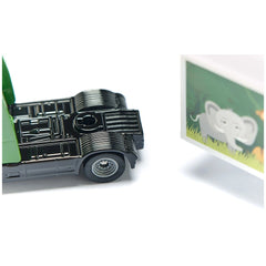 Articulated truck toy in black plastic with metallic sheen alongside a green elephant-printed trailer on a white background.