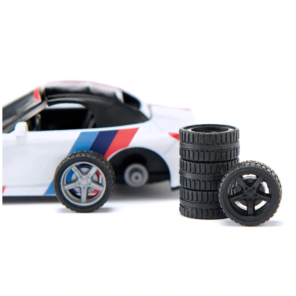 Siku BMW Z4 M40i toy car in glossy white with red and blue stripes, featuring a black interior and silver wheels.