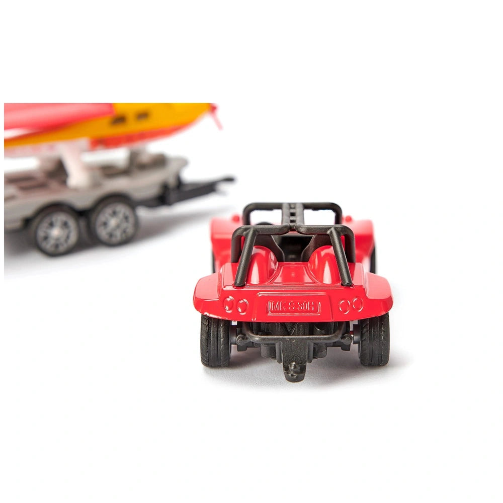 Red toy car with black accents in front of a yellow toy boat on a display base, both made of smooth plastic.