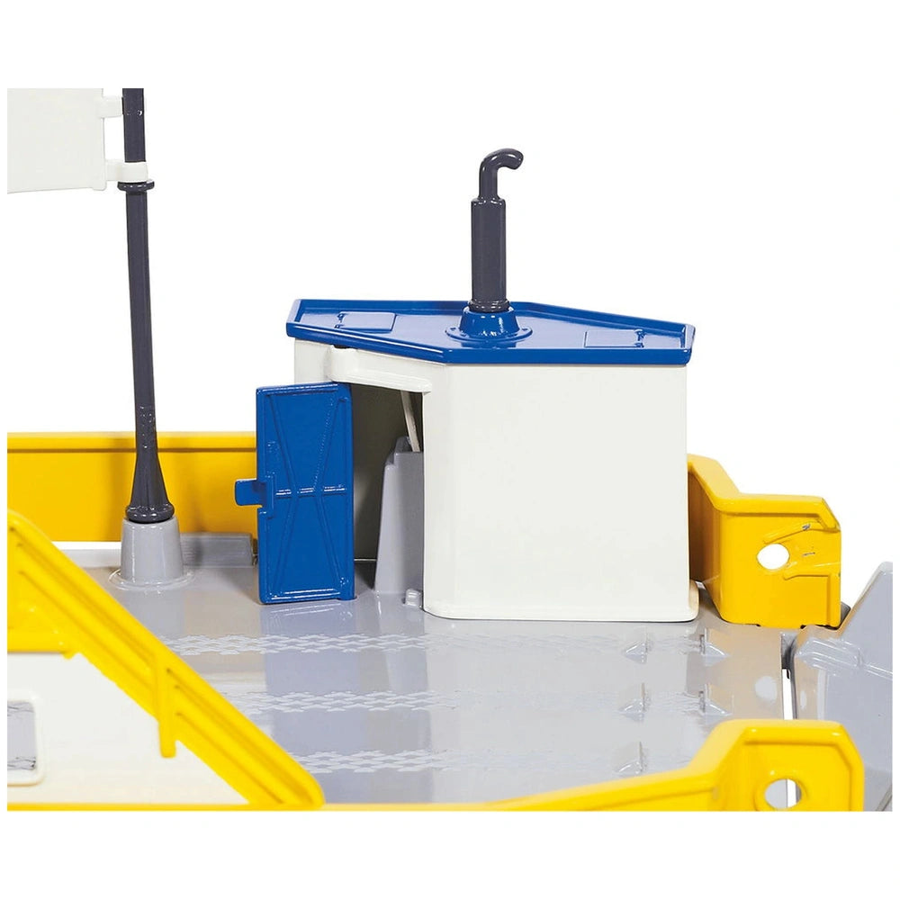 Siku car ferry toy playset features a model sink with blue top, yellow countertop, and black-handled faucet.