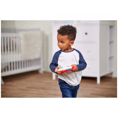 Simba ABC Game Controller toy held by a child in a cozy room with wooden floors and white furniture.