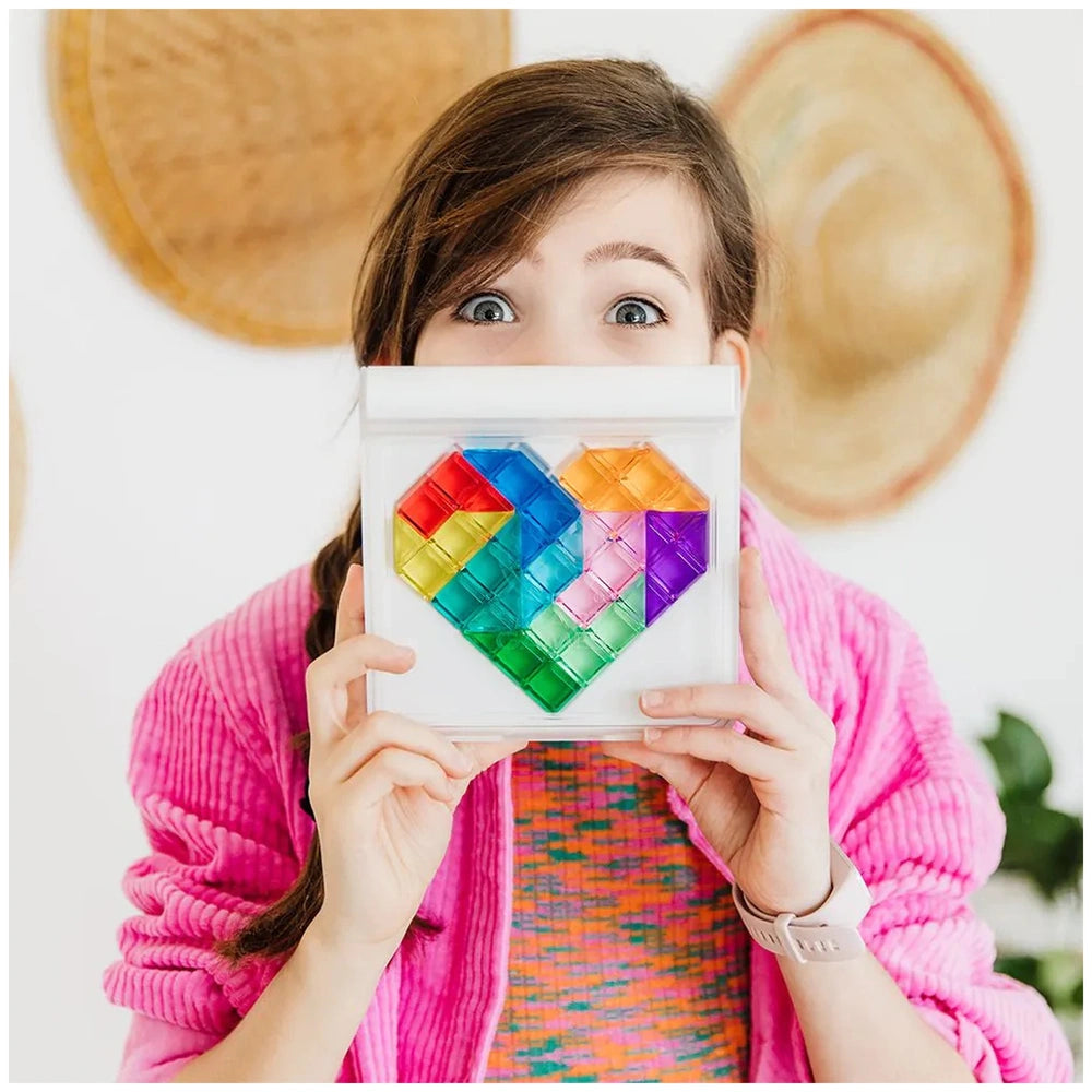 Smart Games IQ Love logic puzzle box held by a girl in a pink garment, featuring a vibrant, colorful pattern.