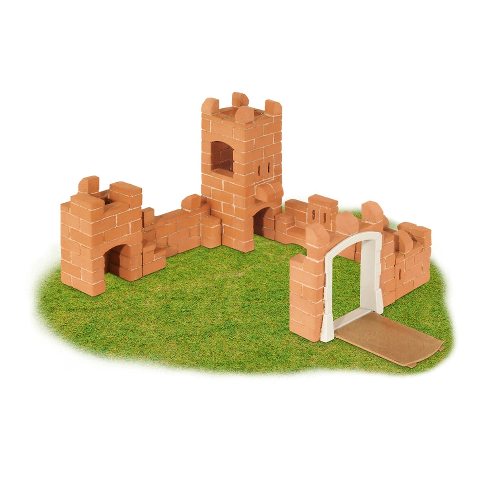 Teifoc castle made of brown bricks features a white archway, set on a natural green surface.
