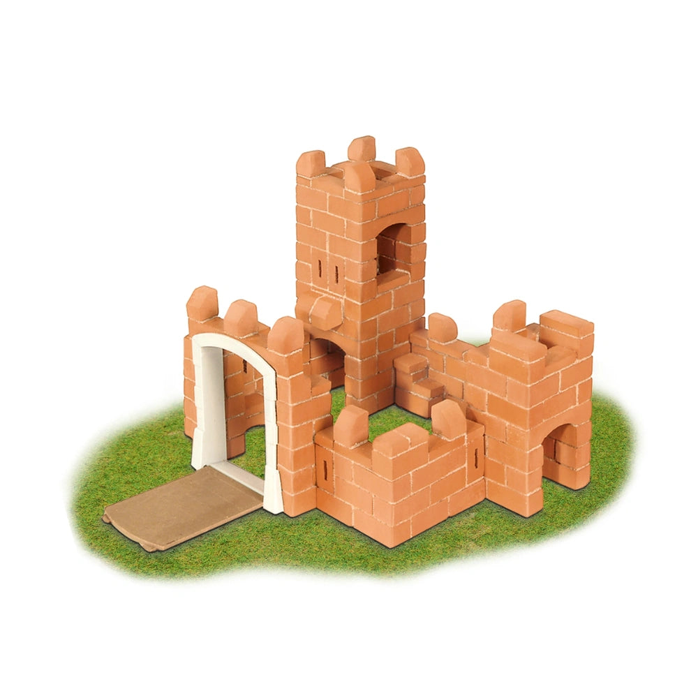 Teifoc castle model features orange bricks, a white archway, and a brown roof, set on a vibrant green surface.