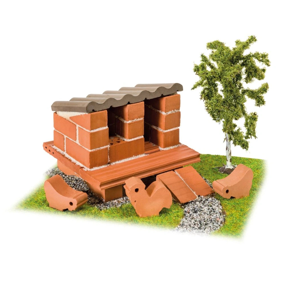Teifoc chicken coop model features a red brick structure with a flat brown roof on a grassy green surface.