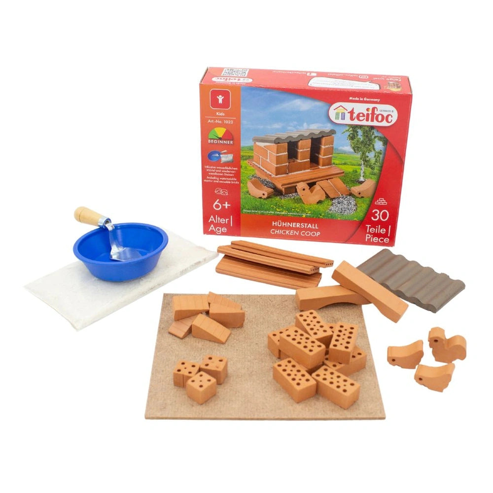 Teifoc chicken coop construction set with wooden pieces, a blue bowl, and colorful box illustration on a light surface.