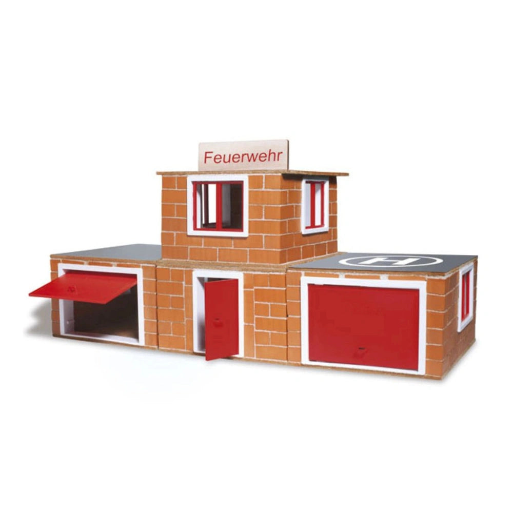 Teifoc Fire Station model features a red and gray brick-like design with a "FEUERWEHR" sign, crafted from cardboard.