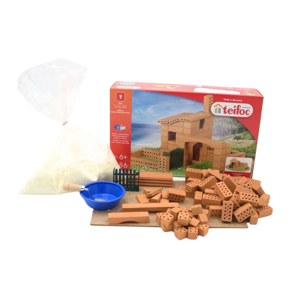 Teifoc Spanish style house construction toy set with colorful bricks, a blue bowl, and a wooden spoon in a boxed package.