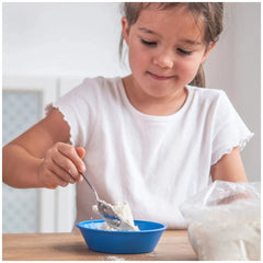 Teifoc water-soluble mortar is featured alongside a young girl happily eating from a blue bowl at a wooden table.