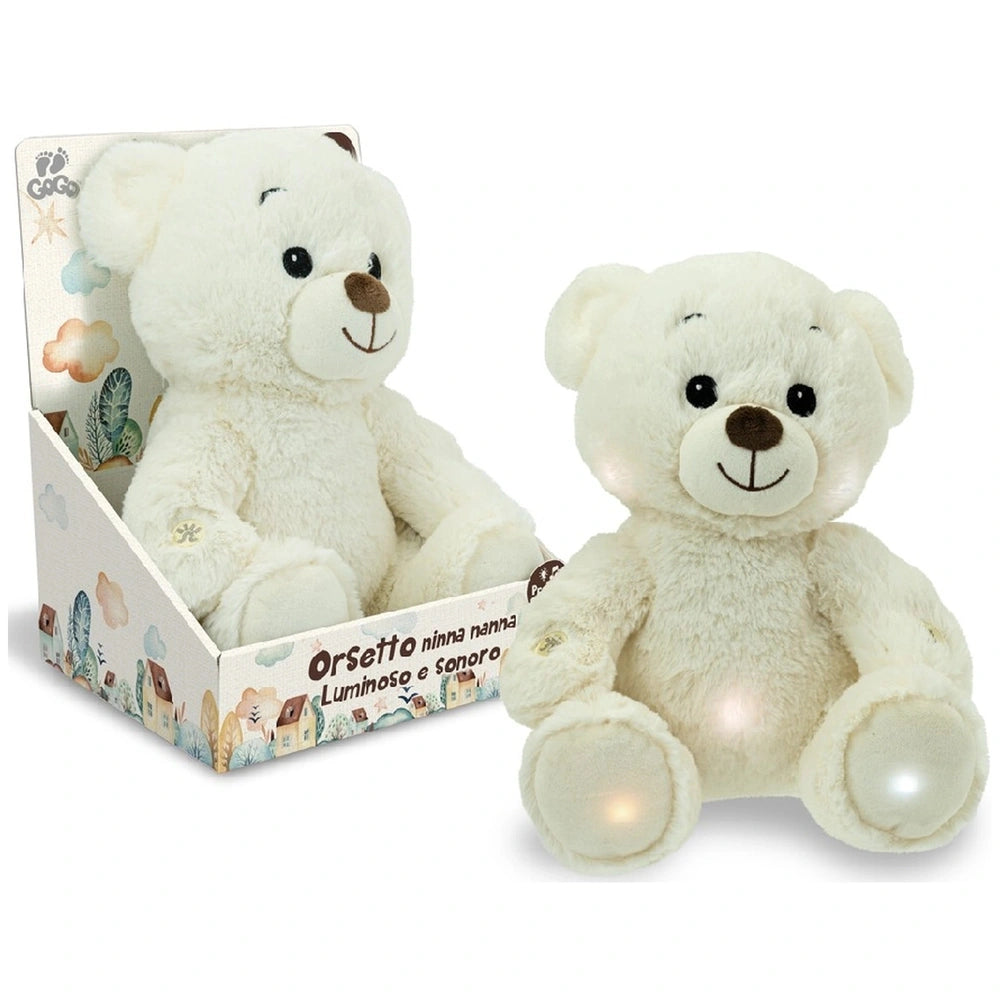 Teorema GoGo Luminous Sleep Aid Bear is a soft, white teddy bear sitting upright in a colorful cardboard box.
