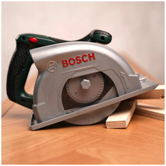 Bosch circular saw in silver with black and green handle, featuring a cutting wheel, trigger mechanism, and power cord.