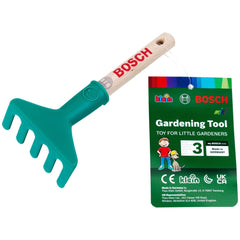 Theo Klein Bosch Garten hand rake in green plastic with cardboard packaging featuring red and white text for outdoor play.