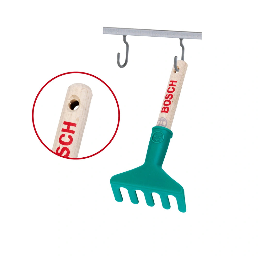 Theo Klein Bosch Garten hand rake with a wooden handle, plastic head, and metal hook, featuring a red circle around the handl