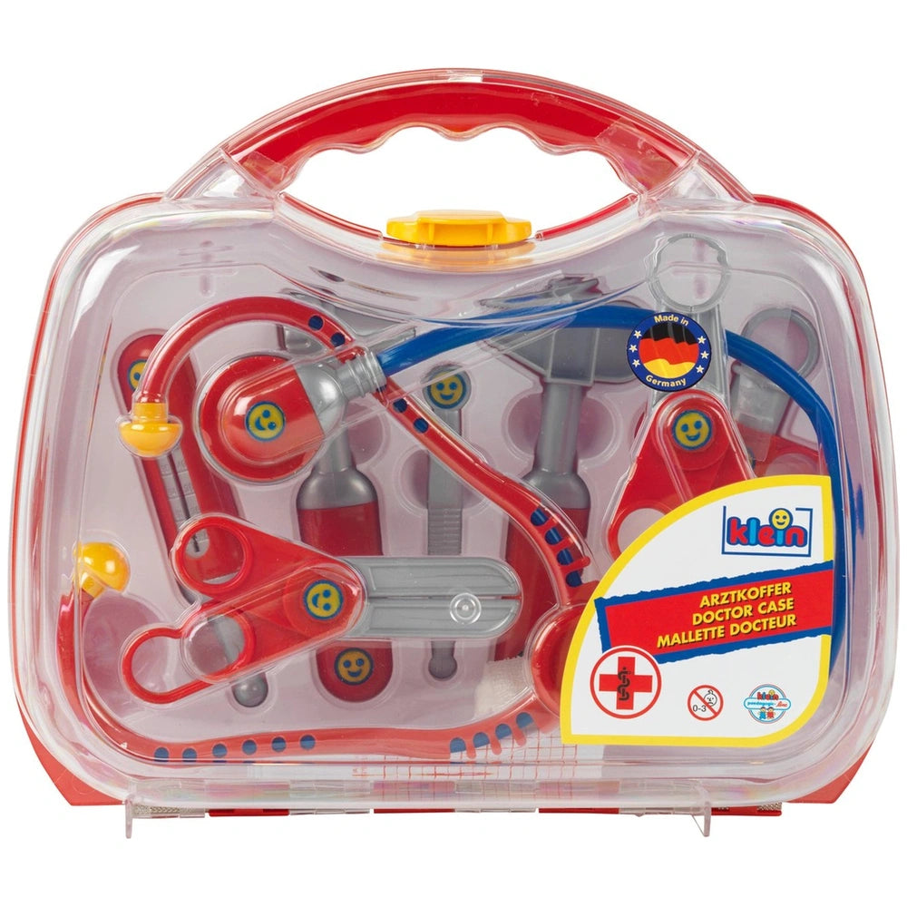 Theo Klein Doctor Case in transparent packaging, featuring red and blue plastic tools, red handle, and yellow button.