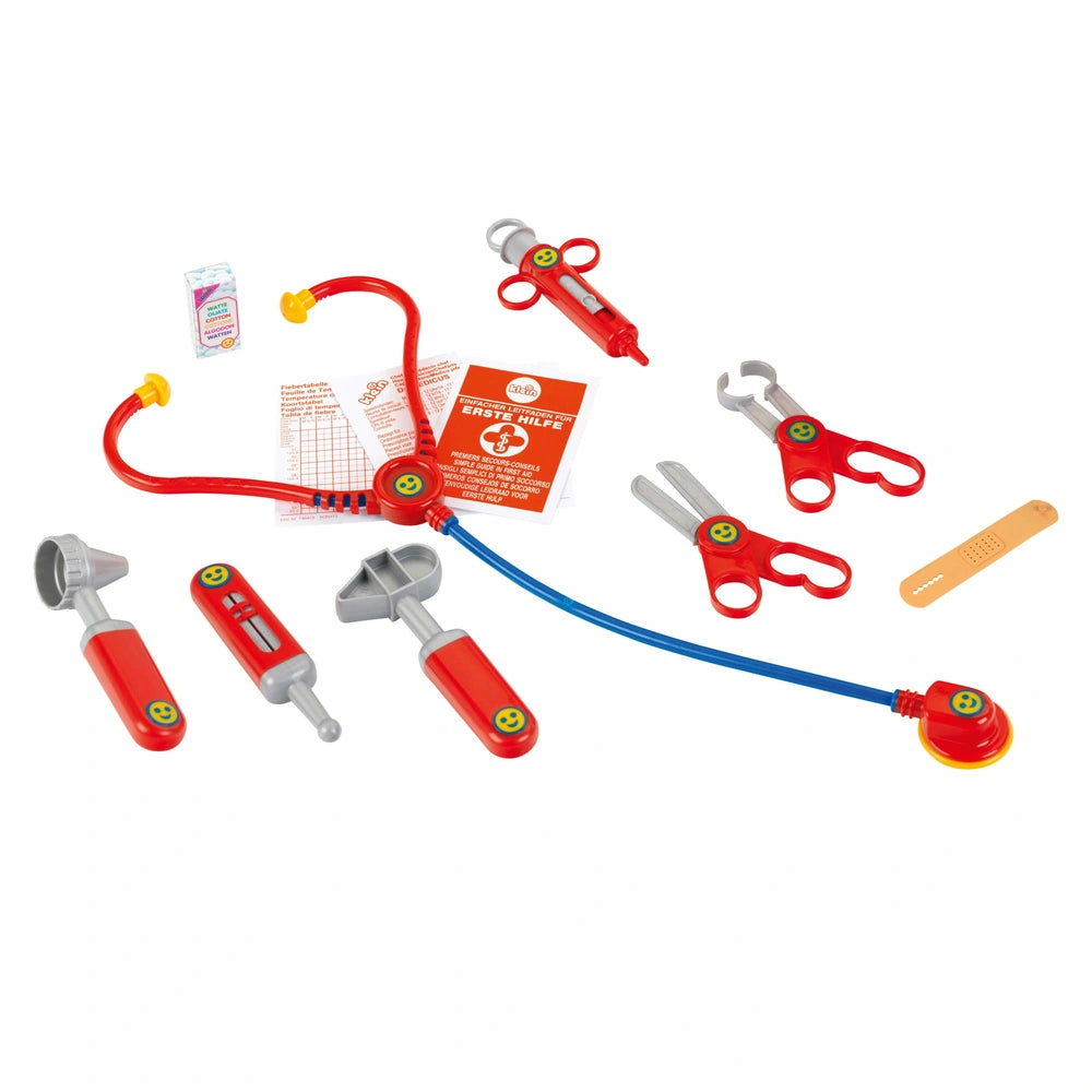 Theo Klein Doctor Case with red stethoscope, blue tube, silver scissors, and orange paper in a trapezoidal layout.