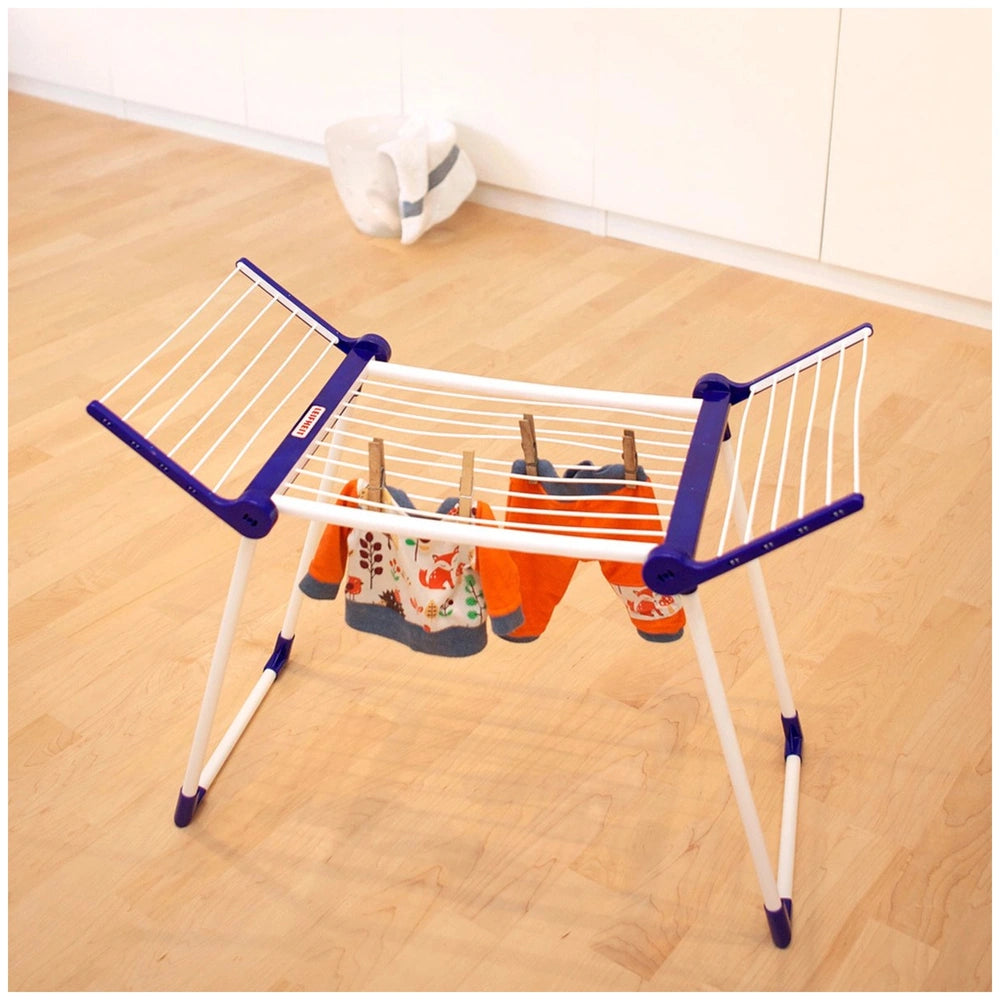 Theo Klein Leifheit drying rack in white and blue with orange and white clothes hanging on it.