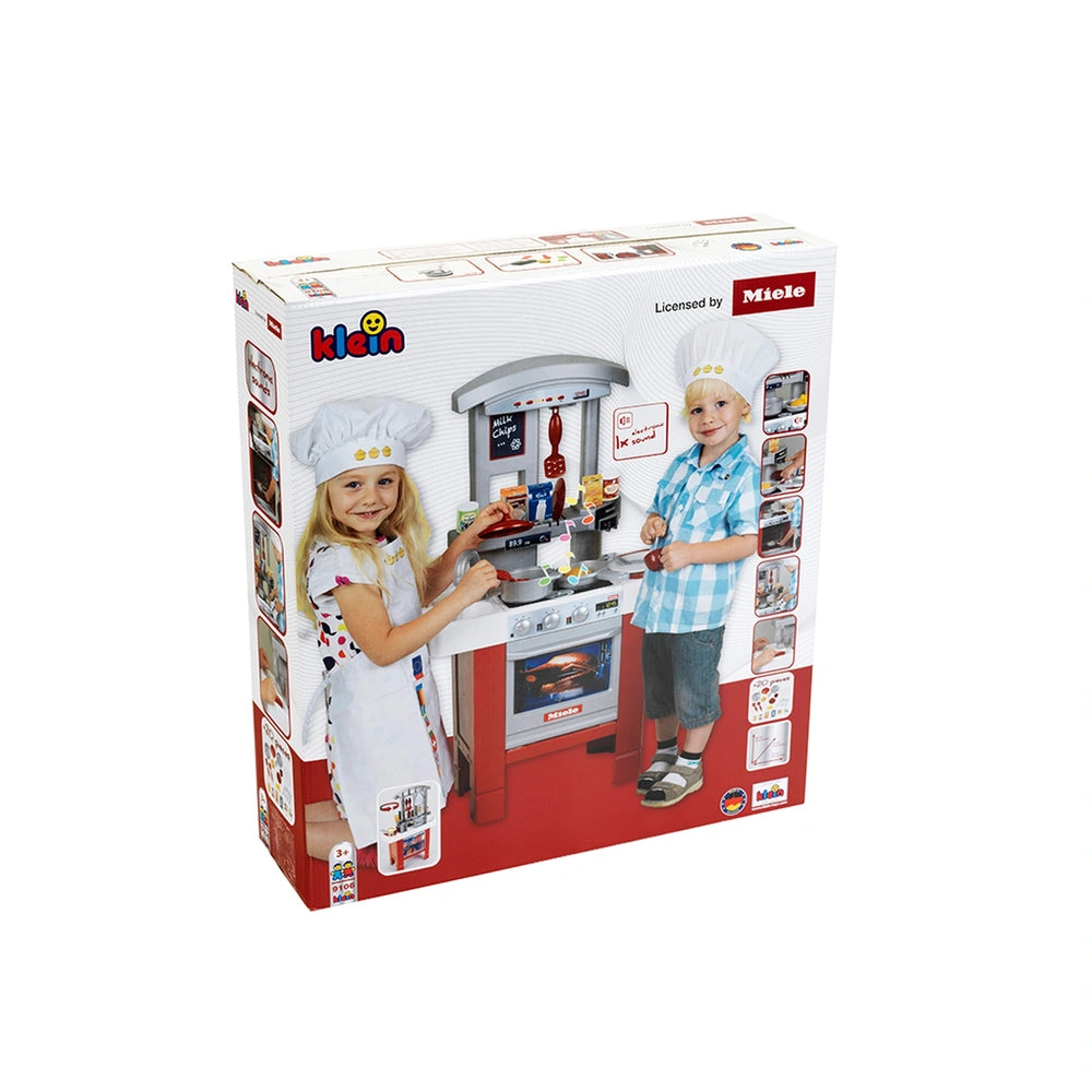 Theo Klein Miele Kitchen Starter packaging features two children in chef outfits with a red oven and cake pan, set on a white
