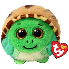 Green turtle plush toy with large black eyes, a smiling mouth, and a red heart-shaped tag on its ear.