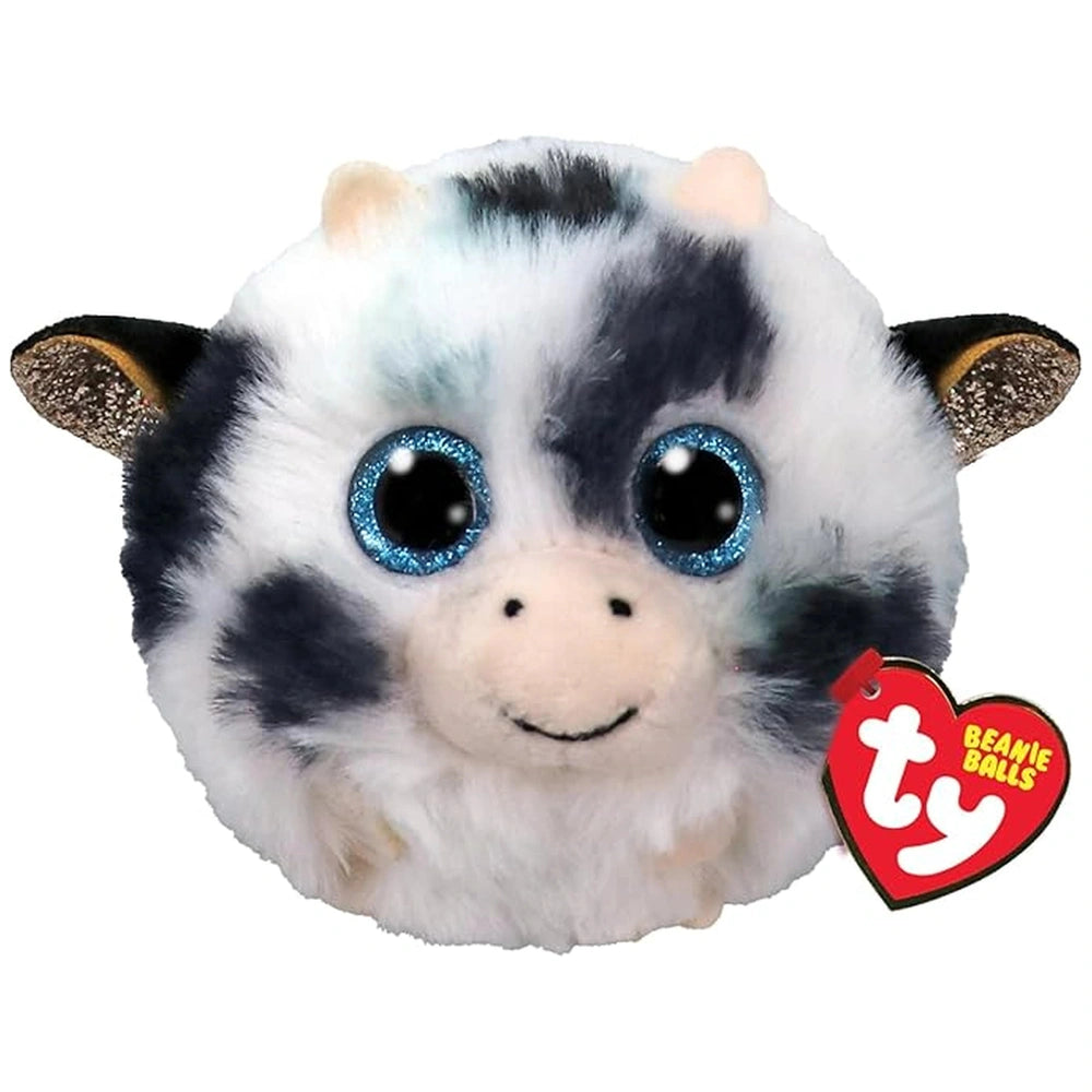 Stuffed toy Moophy Cow features a smiling face with black, white, and blue fur, and a heart-shaped TY tag on its ear.